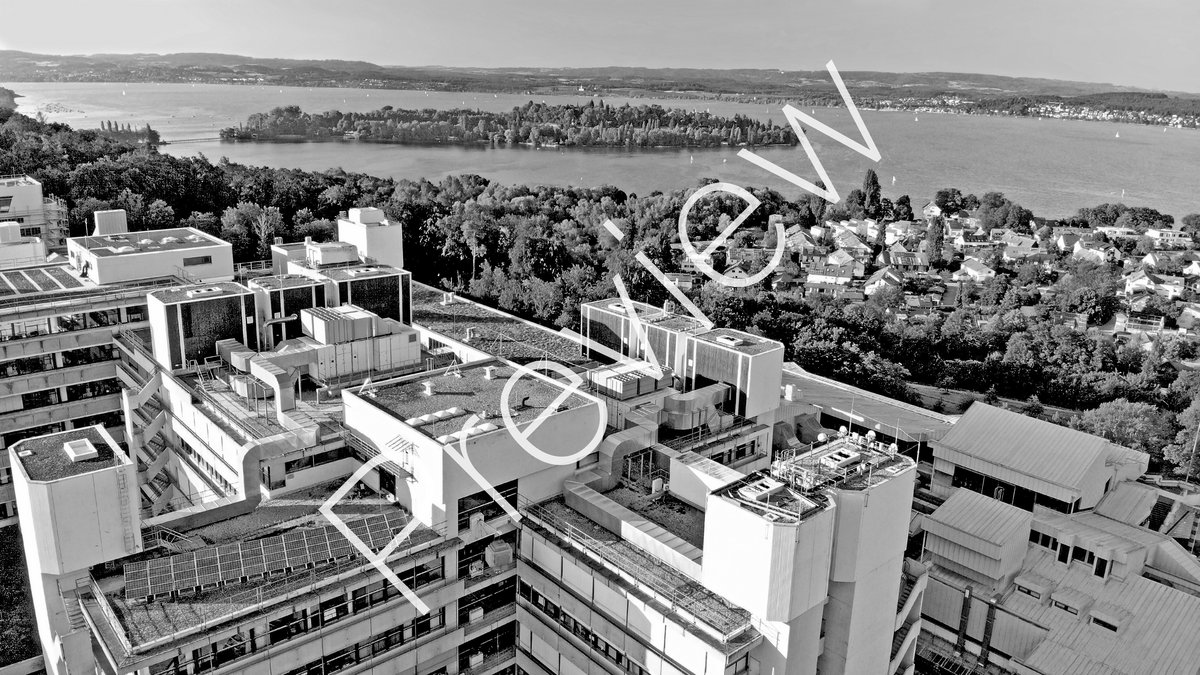 Aerial view of building L,M and lake with Mainau island in the background (with "Preview" watermark) Black and white