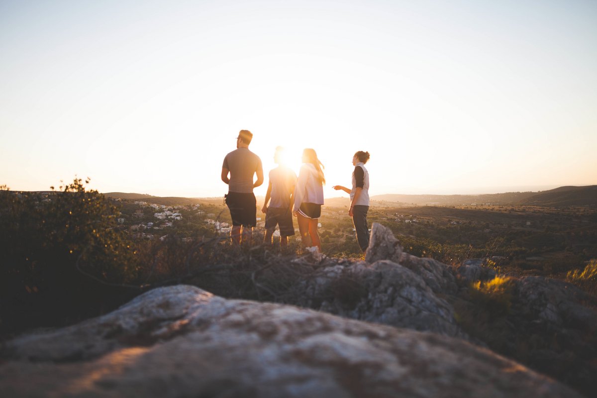 Vier Freunde vor einem Sonnenuntergang, Foto: Unplanned Moments GmbH